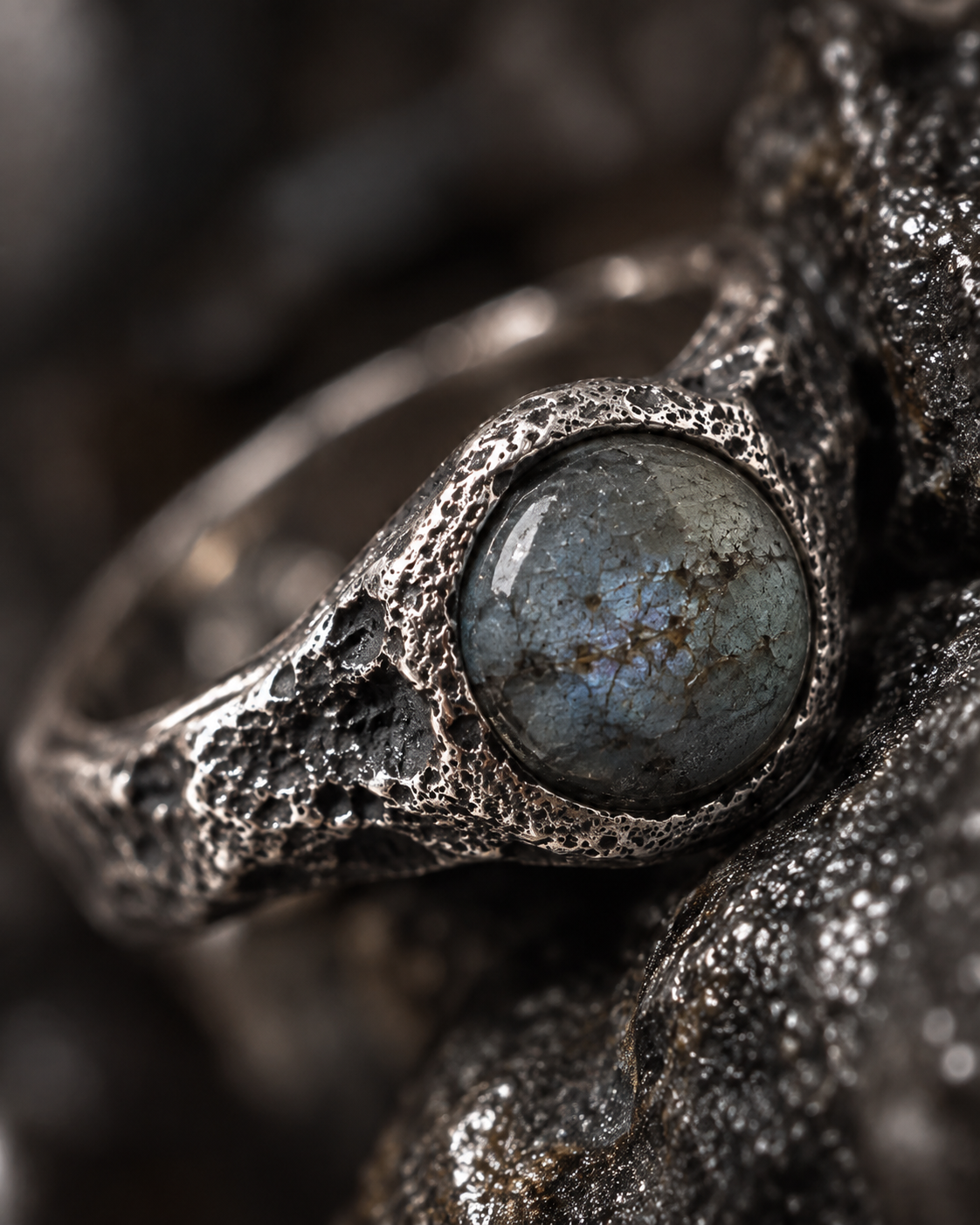 Labradorite set in cratered silver, close up