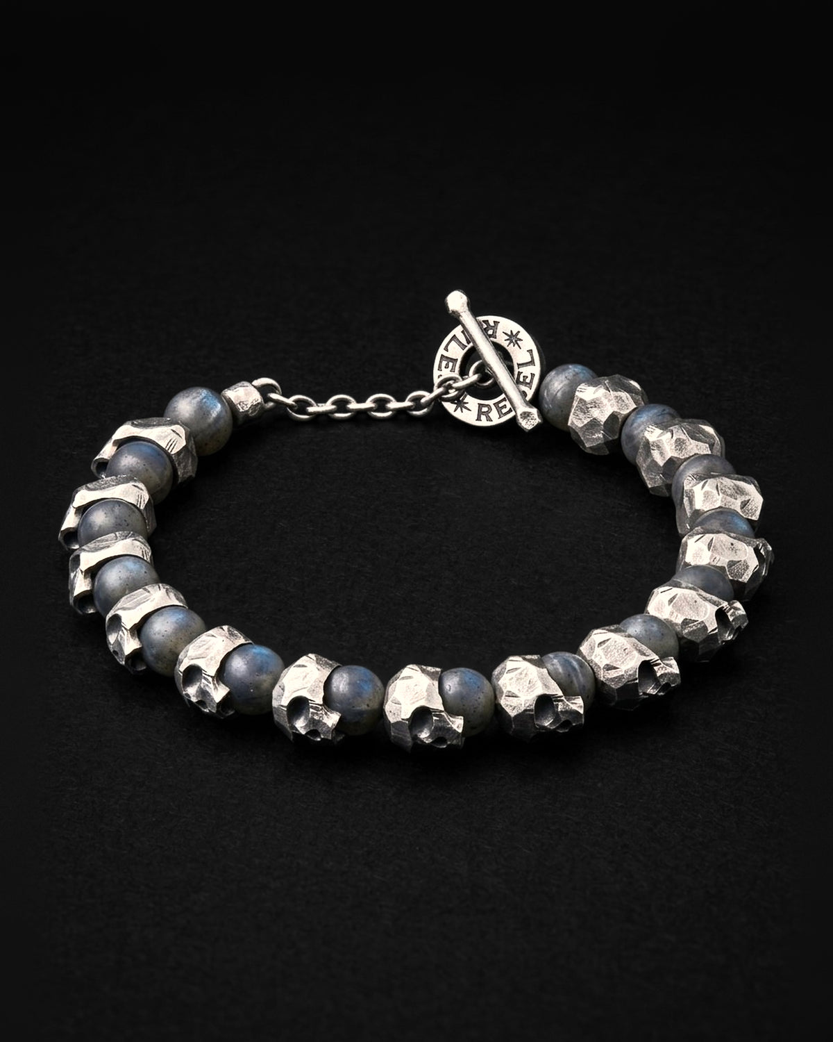 Raw I Bracelet in Labradorite Matte, cast silver skull beads between matte labradorite beads, with the REBEL RULES toggle clasp, on black