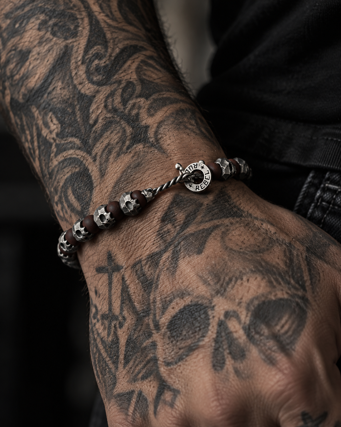 Raw I Bracelet in Red Brecciated Matte, on a hand tattooed with a skull