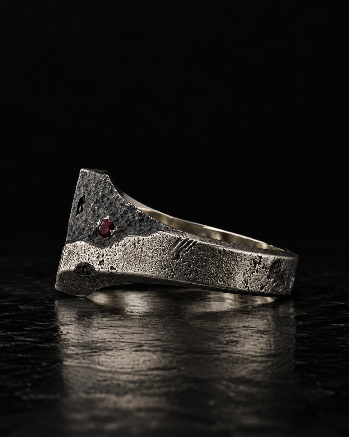 Raw I Ring profile with one red stone set low in the shoulder