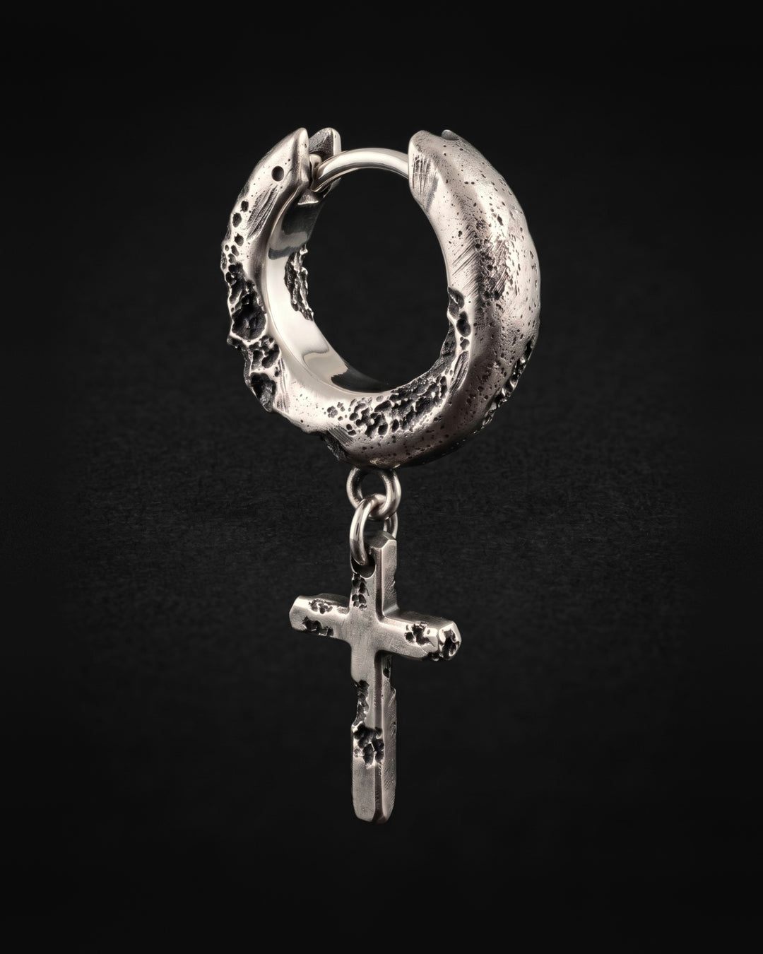 Raw II Earring from the other side, the mirror-polished inside of the hoop and the cross hanging below