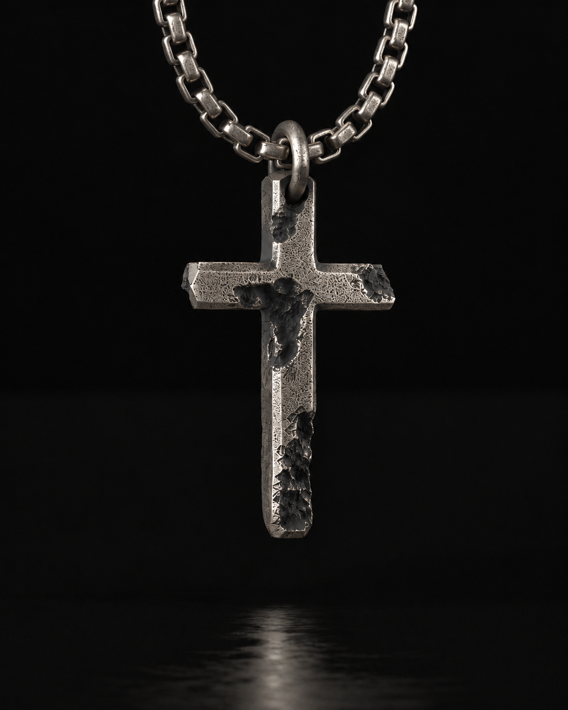 Raw II Pendant close up, pitted craters cut across the arms of the cross