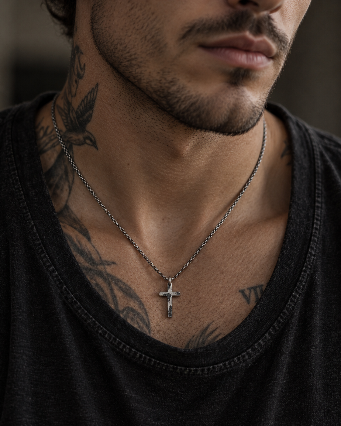 Raw II Pendant over a black tank top on a tattooed neck