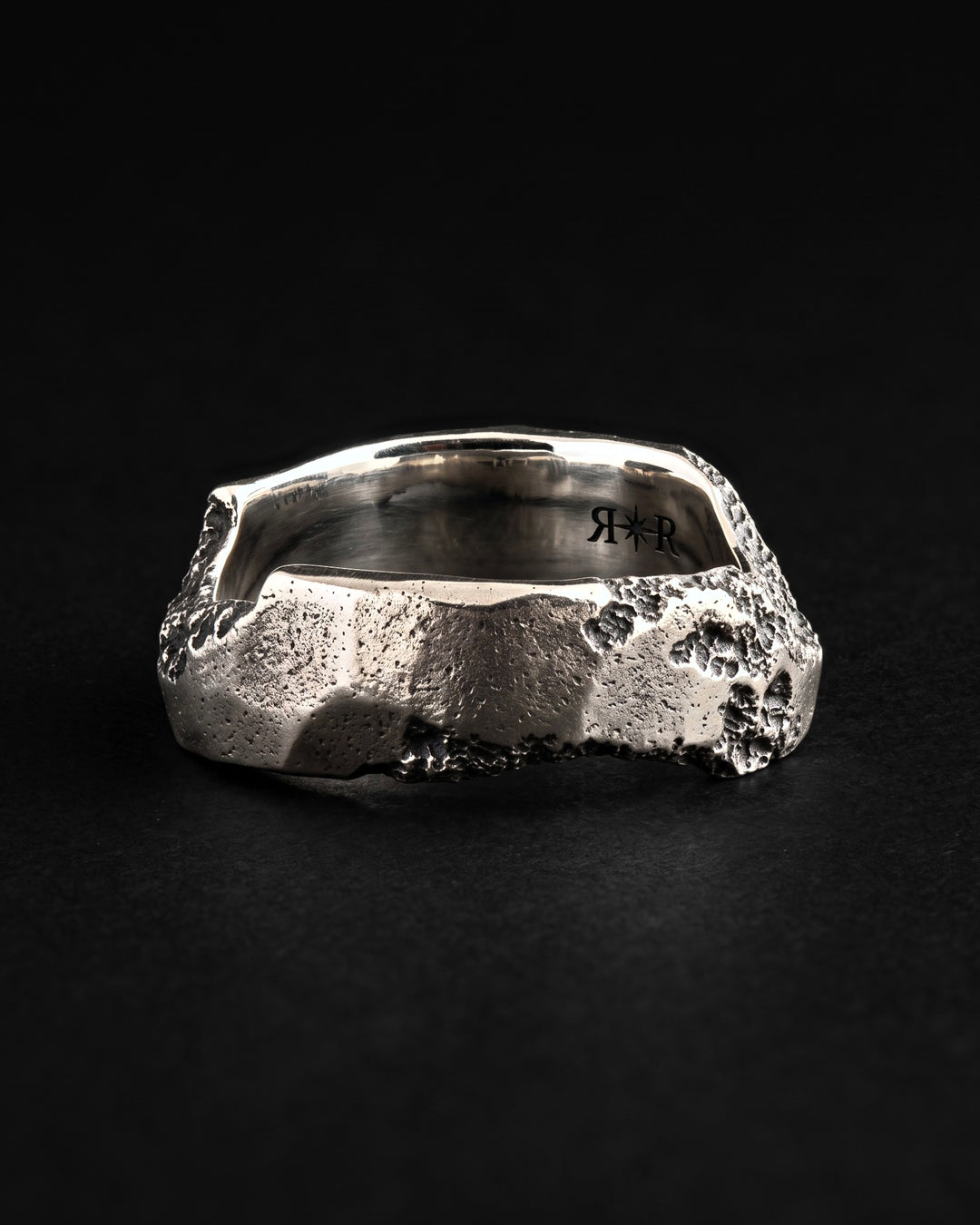 Raw VI Ring with the RR star hallmark laser engraved inside the mirror polished band, dark craters on the rim