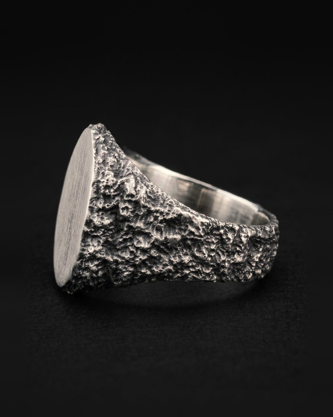 Raw VII Ring in side profile, the brushed plate edge on and crusted texture across the whole outer shank