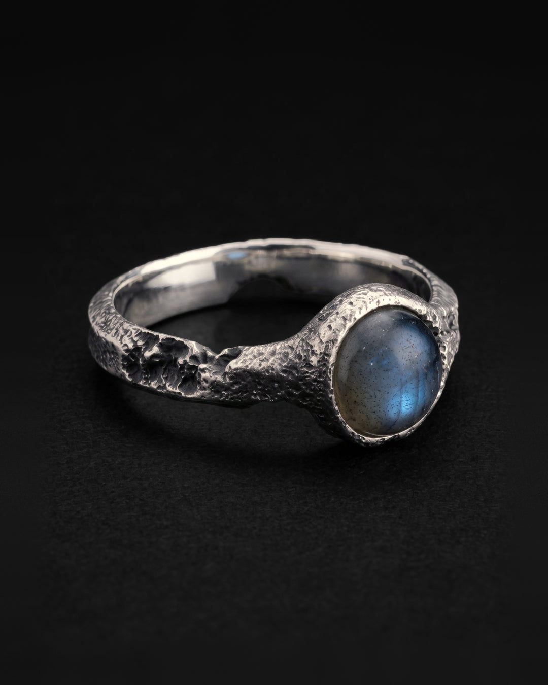Raw VIII Ring angled to show the labradorite cabochon, the pitted band and the mirror polished inside