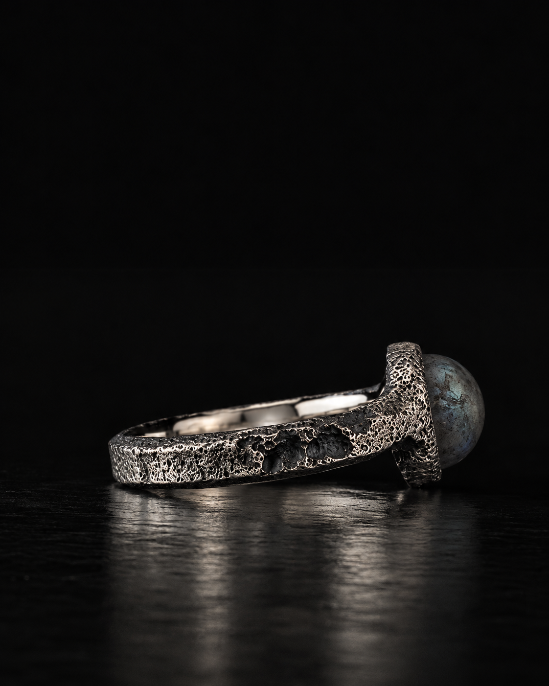 Raw VIII Ring seen from the side, pitted outer band and smooth inner band, labradorite at the edge