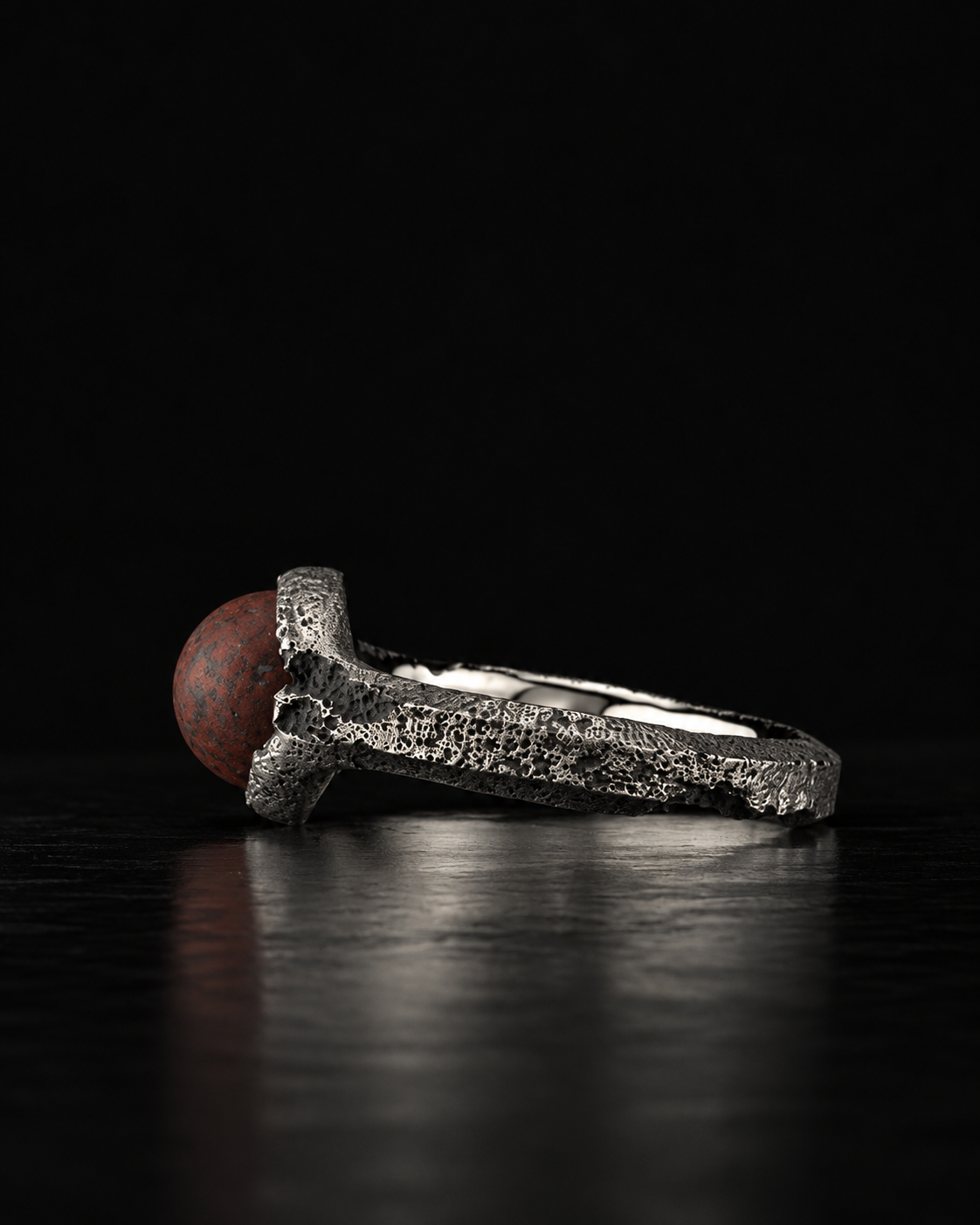 Raw VIII Ring from the side, red brecciated stone at the left, open band and smooth inner surface